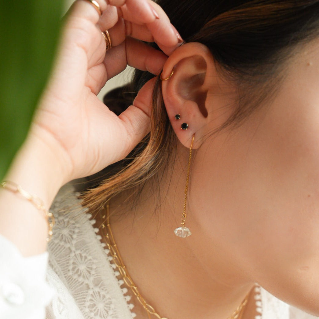 Woman wearing Gold Filled Herkimer Diamond Thread Earrings and 2 black studs 