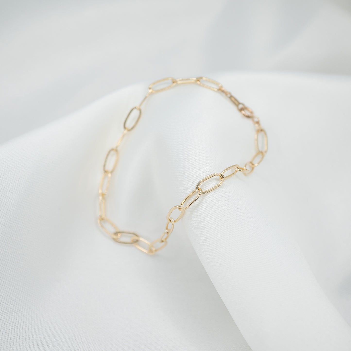 Gold Filled Paperclip Chain Bracelet - draped over white cloth