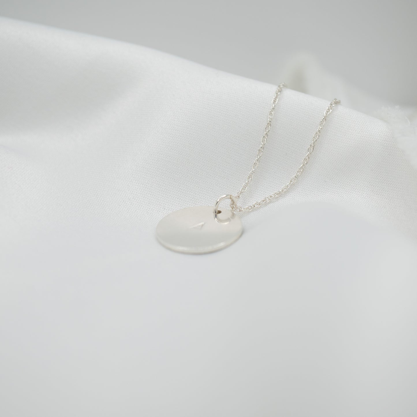 Sterling Silver Hand Stamped Round Pendant and Necklace - shot on white - side left