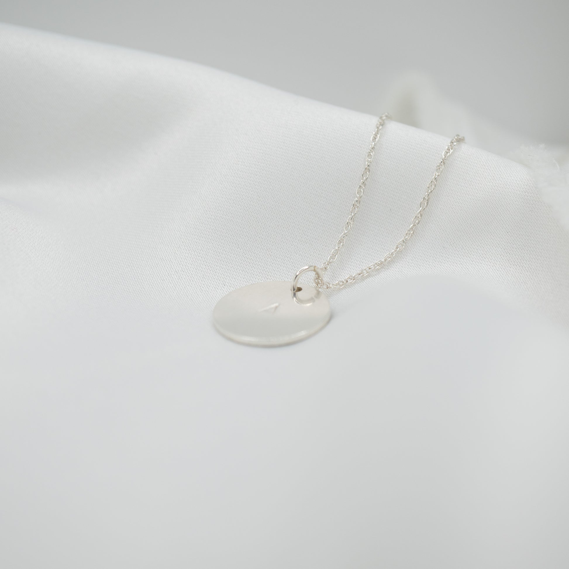 Sterling Silver Hand Stamped Round Pendant and Necklace - shot on white - side left
